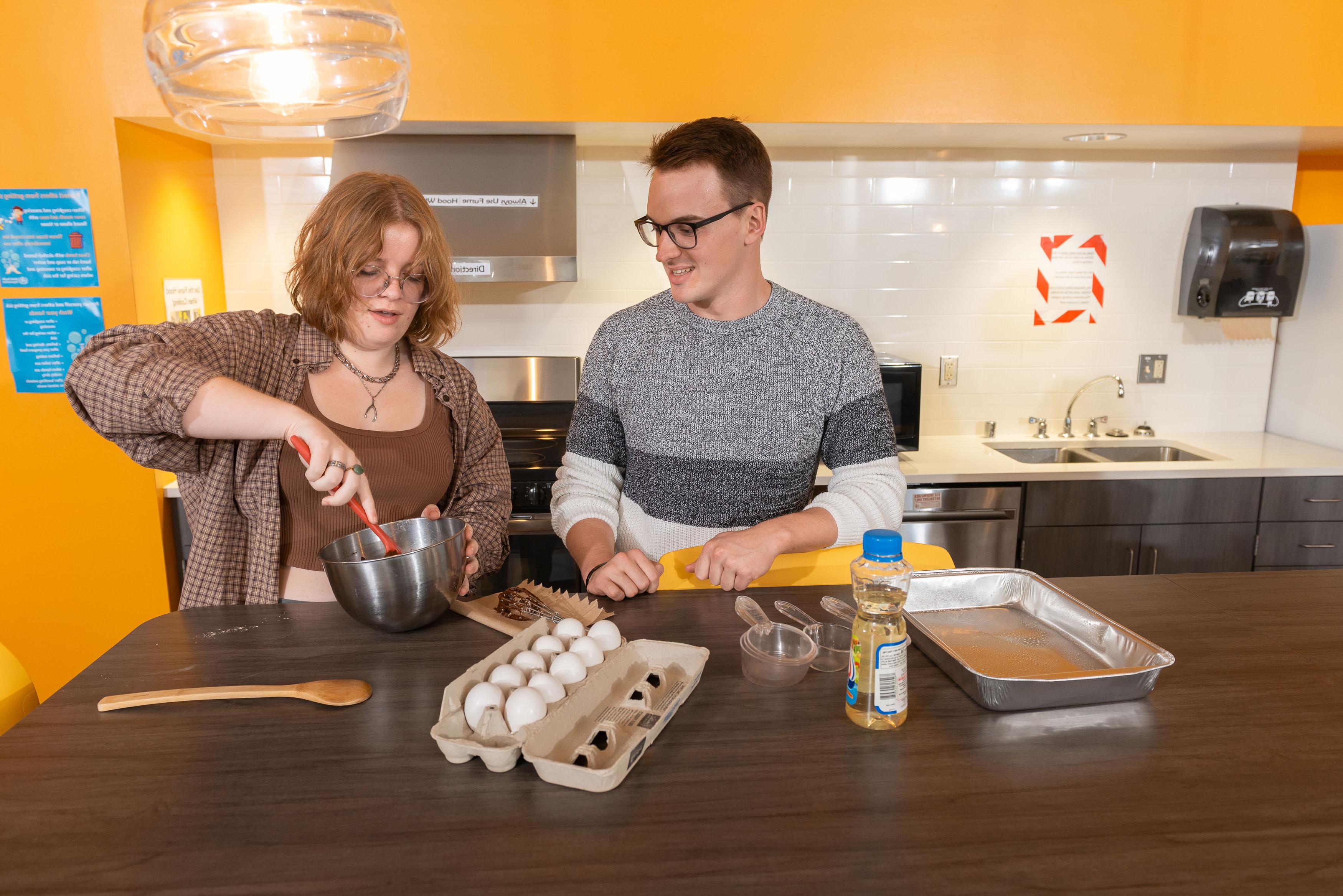 Students making cookies in The Suites residence hall.