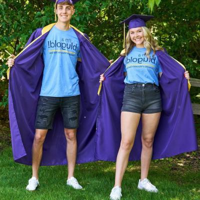 Two students graduating from high school show off their Blugold attire.